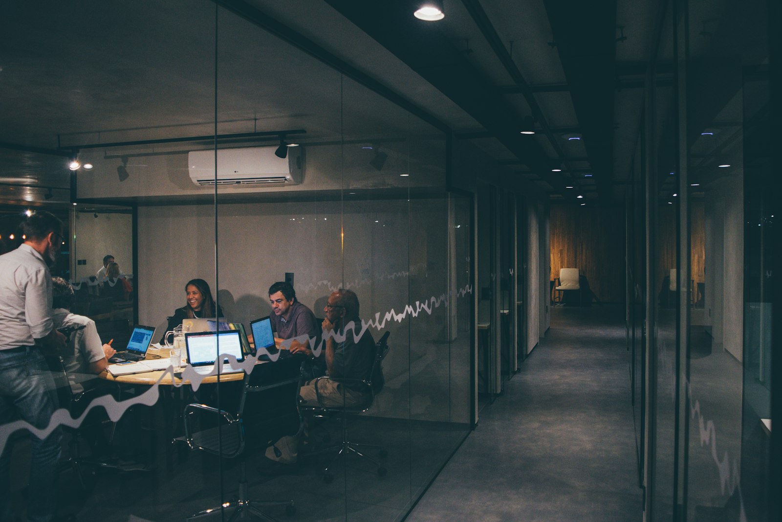 Startup team meeting in a glass-walled office